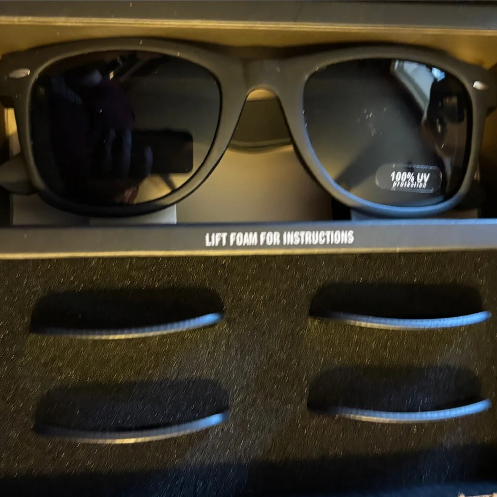 Sunglasses with three interchangeable lenses, dark, yellow, and blue.